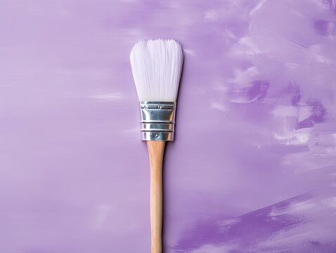 Paintbrush on an empty violet background, with copy space for photo text or product, blank empty copyspace symbolizing the idea