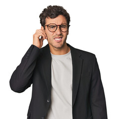 Young Hispanic businessman covering ears with hands.