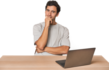 Hispanic young man working on laptop relaxed thinking about something looking at a copy space.