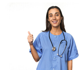 Hispanic nurse in uniform with stethoscope smiling and raising thumb up