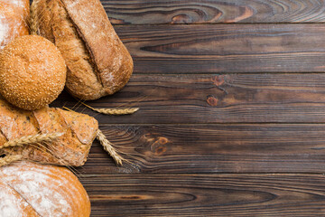 Homemade natural breads. Different kinds of fresh bread as background, top view with copy space