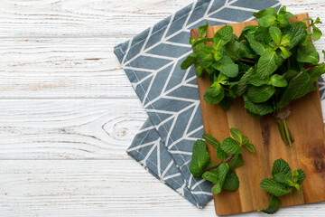 Fresh mint on Cutting board table, top view. Flat lay Space for text
