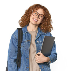 Young Caucasian redhead student with books happy, smiling and cheerful.