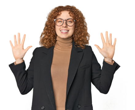 Young Caucasian redhead in business attire showing number ten with hands.