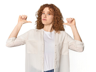 Young Caucasian redhead woman feels proud and self confident, example to follow.
