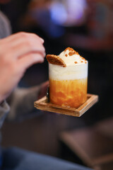 orange cocktail with caramel and whipped cream