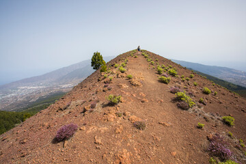 A young woman walking towards Birigoyo peak, La Palma Island, Canary Islands.