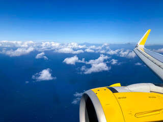 Airplane flight. Wing of an airplane flying above the clouds and sea in La Palma, Canary Islands....