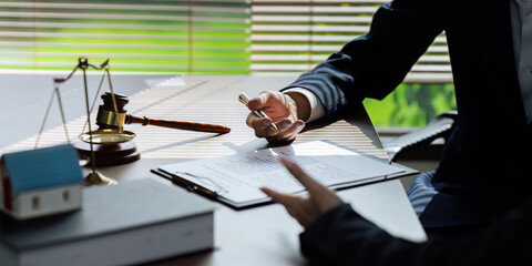 lawyers are drafting a contract for the client to use with the defendant to sign