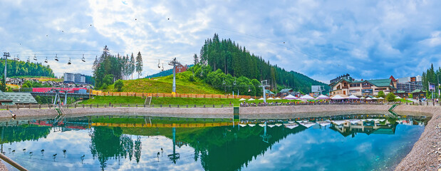 Panorama of Trout Pond, cable car and mountains of Bukovel, Ukraine