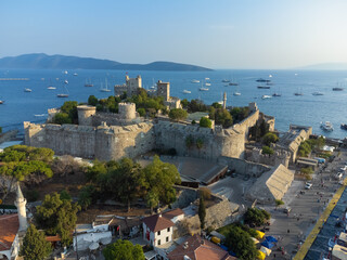 Amazing drone view of the ancient Kalesi Castle or St. Peter's Castle and Bodrum Harbor with...
