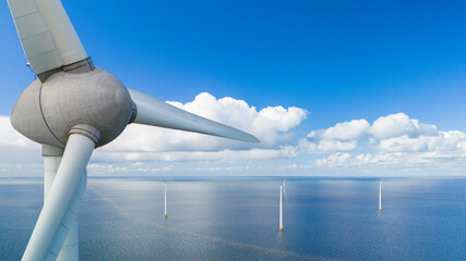 A single wind turbine stands tall in the middle of the vast ocean, harnessing renewable energy...