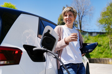 Enjoying a peaceful moment with a coffee during an EV charging session.