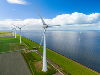 Serene wind farm with sleek turbines dancing gracefully near the ocean in the Netherlands on a...