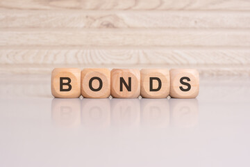 wooden cubes with letters form the expression BONDS. finance and business concept