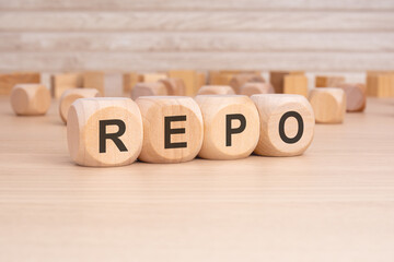 short word english text REPO on a wooden cubes with wooden background