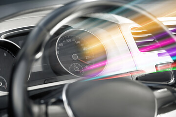 Speedometer behind steering wheel in car, motion blur effect