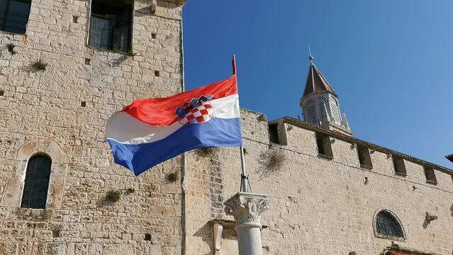Croatian flag on a flagpole in the city of Trogir, Croatia