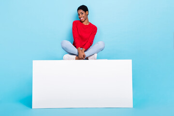 Photo of charming pretty good mood female sitting white podium relaxing isolate on blue color...