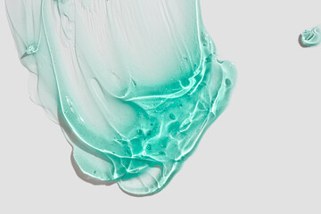 Liquid gel cosmetic smudge blue green on gray background