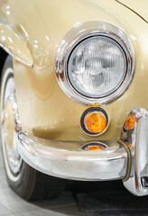 Close up of a yellow vintage car headlight. Classic car.