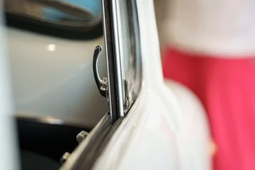Fototapeten A close-up of an old vintage car window crank. © Skatty