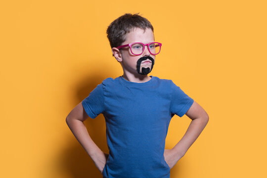 Boy in Costume with Glasses and Fake Beard on Yellow Background