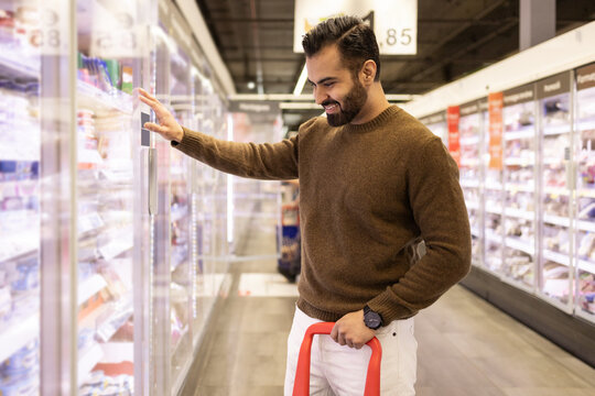 Cheerful Shopper Choosing Frozen Goods