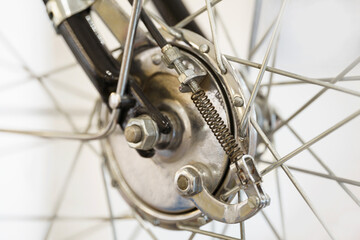 Close up and detail of a vintage motorcycle wheel and spokes. White background. 