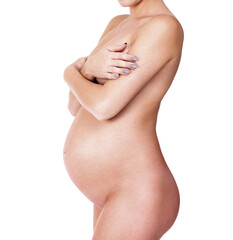 Naklejka premium Naked pregnant woman posing against white background, isolated