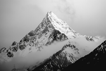 A black and white image of a mountain peak, emphasizing its stark beauty.