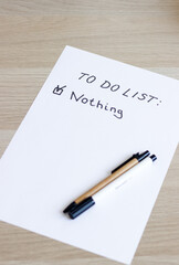 A white blank note or sheet of paper is on a wooden table background. To do list concept with no plans