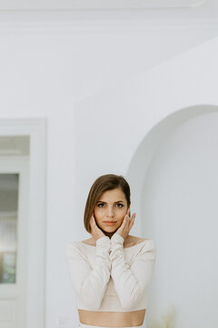 Elegant girl model in studio with white wall