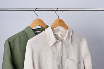 Linen shirts hanging on wooden hangers - 791602946