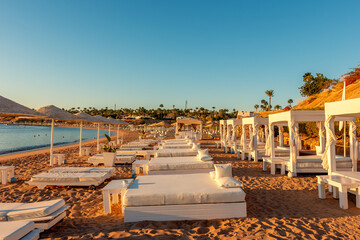 Summer background with tropical beach during sunset. Holiday vacation and travel concept.