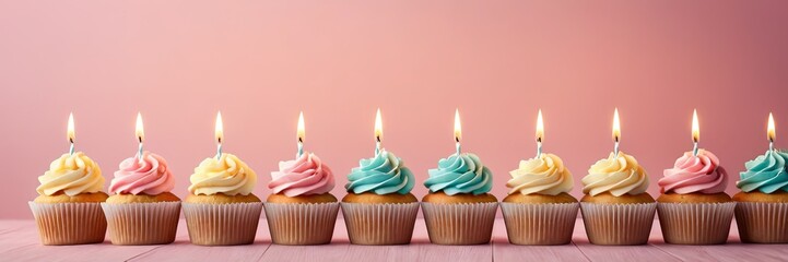 Colorful cupcakes with lit candles are displayed against a pink background, indicating an indoor celebration event marking of joy and celebrating. with free space