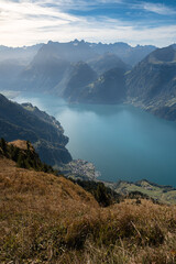 Lake in a valley seen from Fronalpstock summit in Switzerland. Swiss Alps iconic view