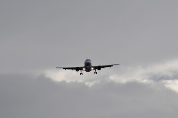 A plane in the sky with clouds