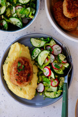 Chicken cutlets on a plate with mashed potatoes and fresh vegetable salad. top veiw