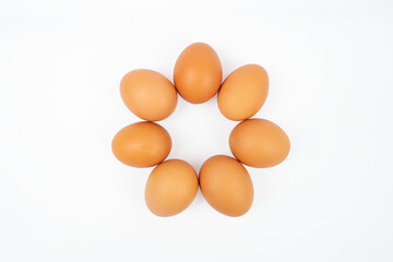 Seven eggs arranged in a ring or circle shape, isolated on white background