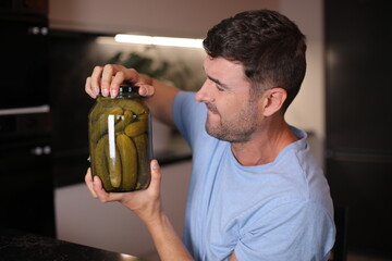 Man trying to open a pickles jar 
