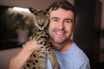 Exotic cat and his owner