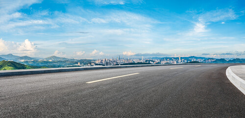 Asphalt highway road and city skyline with green mountain scenery in Shenzhen. Panoramic view.