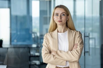 Confident businesswoman standing in modern office setting