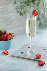 A glass of champagne with strawberries in summer style	