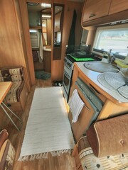 Spacious and contemporary motorhome interior featuring a sleek kitchen, inviting dining area, and a...