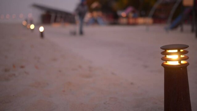 Lighted lantern on background of people walking