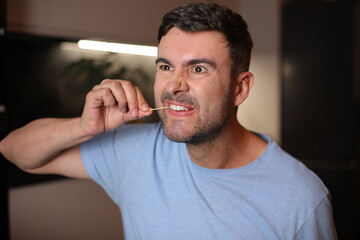 Man using a toothpick after lunch 