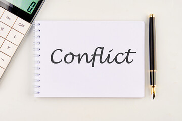 Conflict word on a white notebook