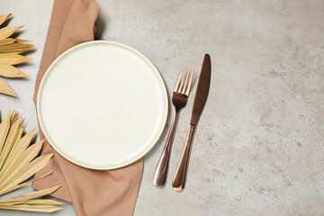 Setting with beautiful cutlery on textured table, top view. Space for text
